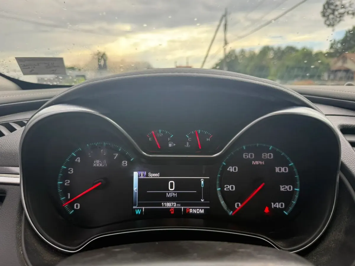 The instrument cluster of a Chevrolet Impala: tachometer, speedometer, fuel and temperature gauges and the odometer display