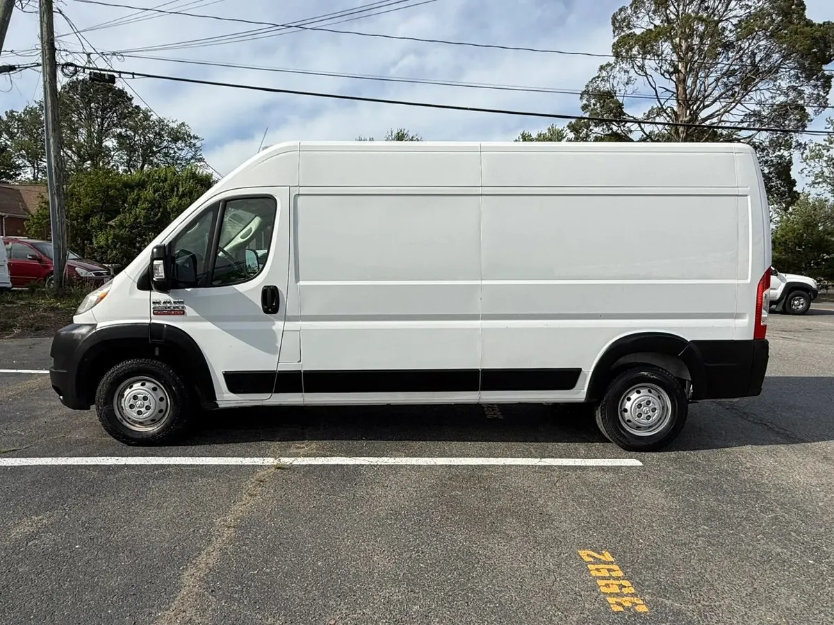 Side profile of a white RAM ProMaster high-roof cargo van with the long wheelbase