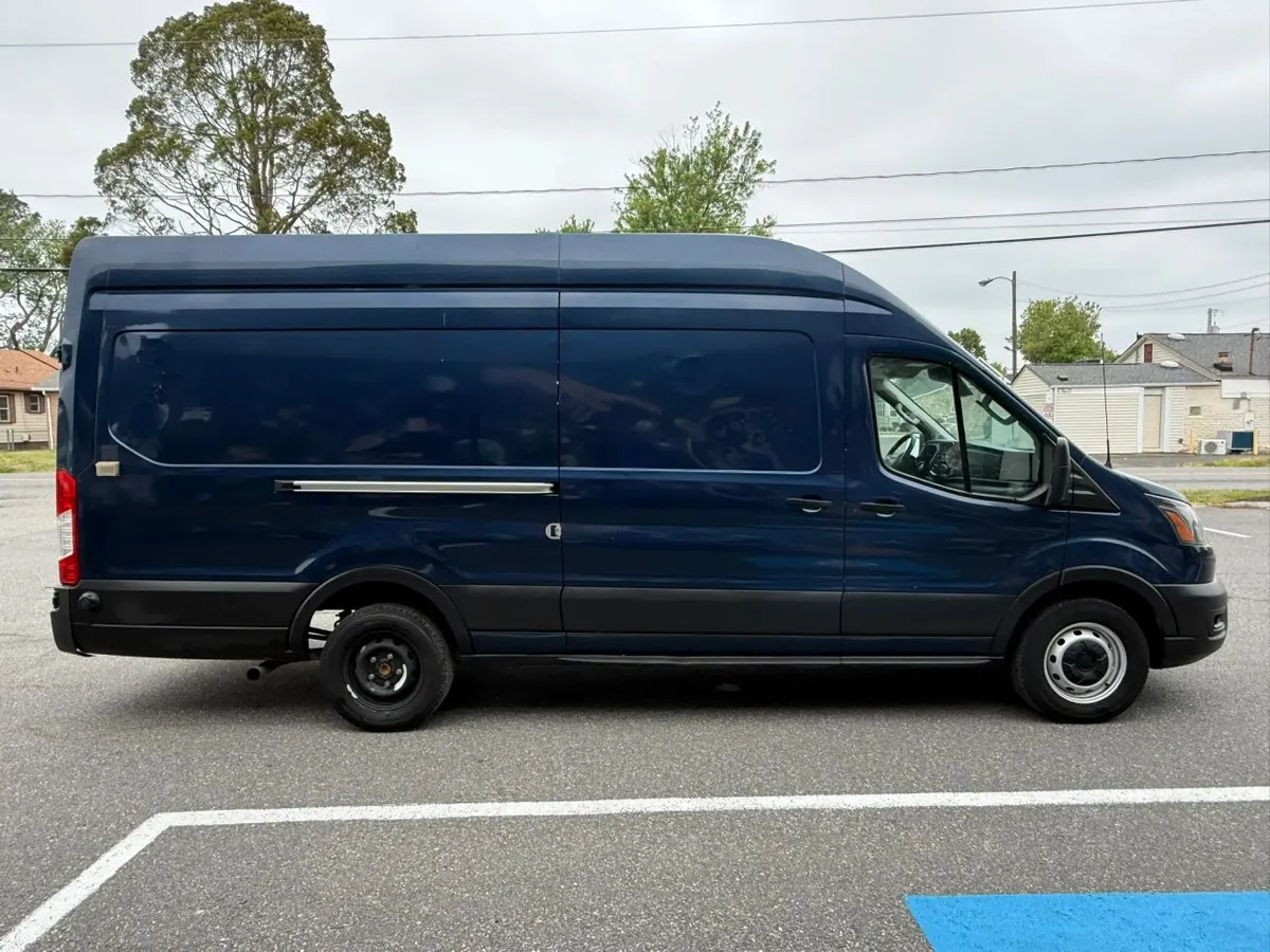 Side profile of a blue Ford Transit extended-length high-roof cargo van